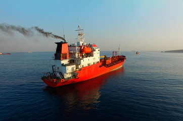 Fototapeta premium Aerial view of the seascape with a red ship against the sea background.