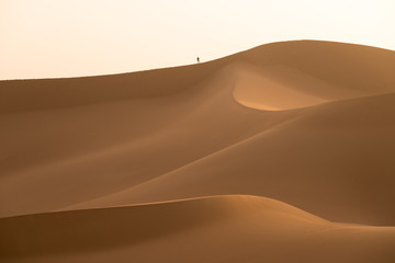 Fototapeta na wymiar Sand mountains and little man silhouette