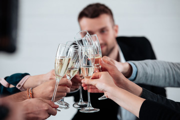 Well done work success young business people toasting each other and smiling while standing in the...