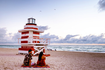 young couple on the beach of Miami during sunset, men and woman Miami beach