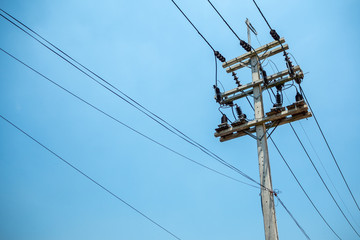 High voltage cables and equipments on pole with clear blue sky background and copy space
