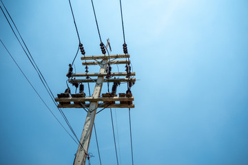 High voltage cables and equipments on pole with clear blue sky background and copy space