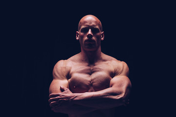 Brutal strong athletic Bodybuilder posing. Bodybuilding and healty life concept