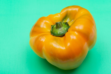 Fresh Ripe Organic Bell Peppers, a cultivar group of the species Capsicum annuum, isolated on green background.
