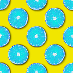 Seamless pattern made of light blue tangerine on a yellow background