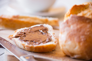 Sliced loaf of wheat bread with peanut butter for breakfast