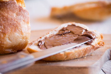 Sliced loaf of wheat bread with peanut butter for breakfast