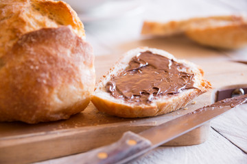 Sliced loaf of wheat bread with peanut butter for breakfast