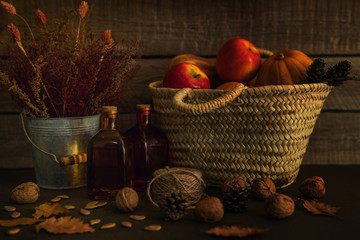 Colored fall vegenables on the vintage boards. Autumn decorations in wicker basket. A cornucopia...
