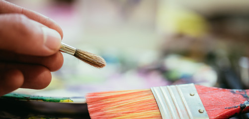 Fototapeta premium Painting artwork: paint brushes on painting background