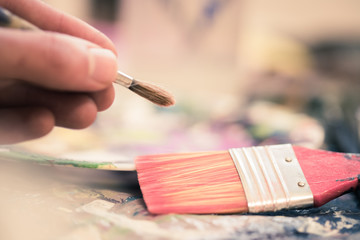 Painting artwork: paint brushes on painting background