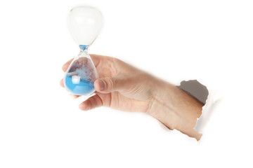 Male hand holding an sand hour glass on white background.