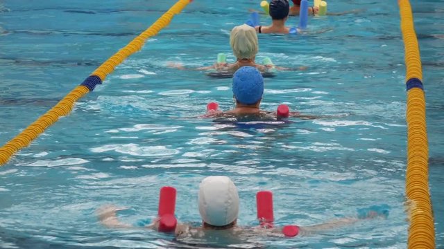 Group Of Older Women Doing Water Aerobics In The Pool