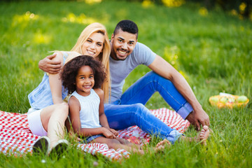 Picture of lovely couple with their daughter having picnic