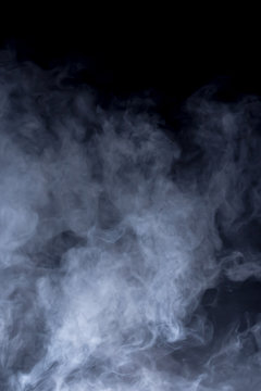 Smoke and fog in front of black background. Concept graphic elements.