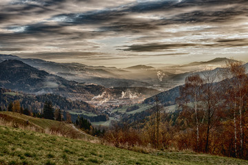 sunrise in the austrian alps shining at a sleeping valley and mystic clouds in styria HDR