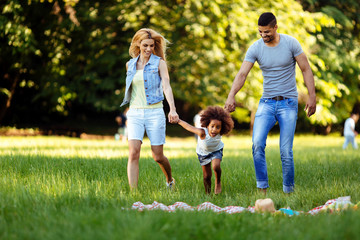 Happy young couple spending time with their daughter