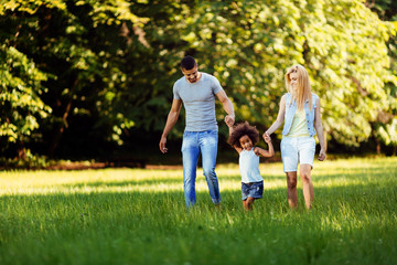 Fototapeta premium Happy young couple spending time with their daughter