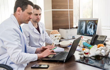 Two doctors having medical council in hospital. Discussing medical issues before brain surgery