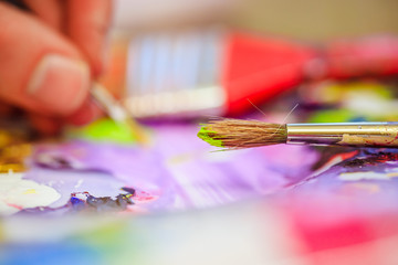 Painting artwork: paint brushes on painting background