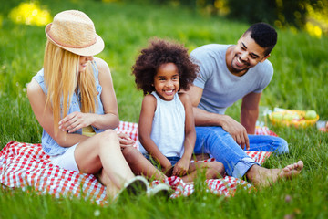 Fototapeta premium Picture of lovely couple with their daughter having picnic
