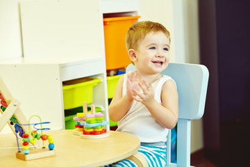 little boy at the table playing in developing game