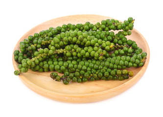 Fresh green peppercorns on white background