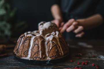 Christmas magic time. Dark baking background with ingredients, holiday natural decorations and utensils. Merry Christmas and Happy Holidays. Family preparation holiday food. Top view. Toned image.