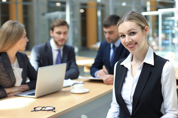 business woman with her staff, people group in background at modern bright office indoors.