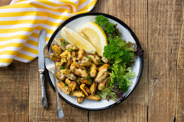 Peeled mussels with fresh lemom. Healthy seafood, natural sunlight, wooden rustic table.