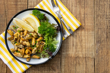 Peeled mussels with fresh lemom. Healthy seafood, natural sunlight, wooden rustic table.