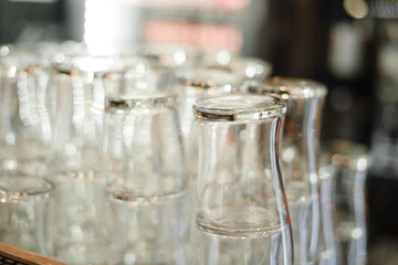 Glasses for alcohol and cocktails. Clean glasses in the restaurant for drinks and soda. Set of empty mugs on the bar counter