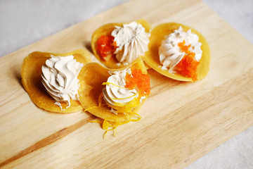 Thai Crispy Pancake (Kanom Buang) on wooden plate isolated on white background