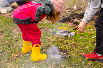 children learn to build a fire in nature