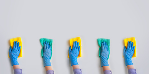 Commercial cleaning company. Employee hands in blue rubber protective glove. General or regular...