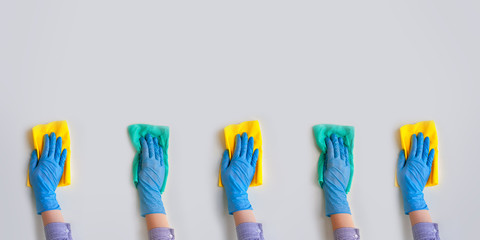 Commercial cleaning company. Employee hands in blue rubber protective glove. General or regular cleanup.