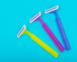 Disposable Women Razors isolated on blue background.