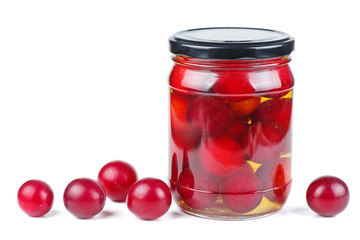 Cherry plums canned in glass jar isolated on white background
