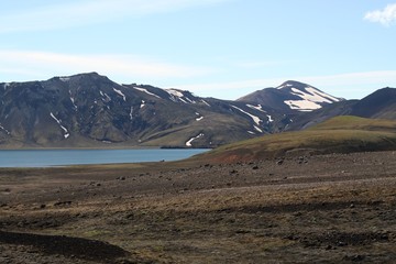 Hálslón lake with snow capped mountain range, Iceland
