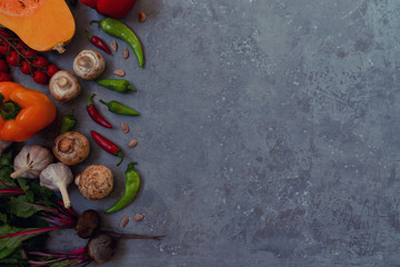 Vegetables on vintage gray background. Autumn harvest. Organic food background. Farmers vegetable market. Seasonal fall vegetables. Rural still life from above with free text space. Toned image.