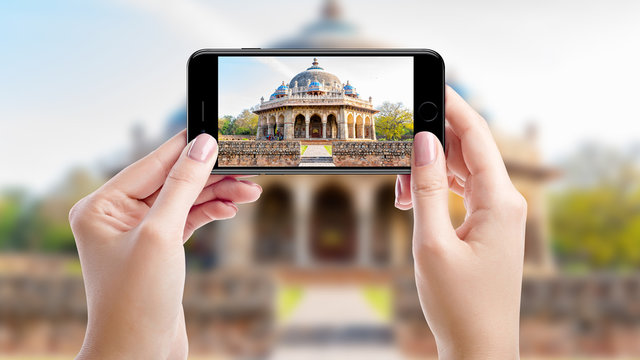 Taking a photo with mobil phone of Humayun's tomb, Top sights of New Delhi, India