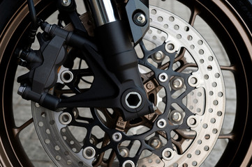 closeup tire and dish bake of  sport motorcycle ( big bike ) with soft-focus  and over light in the...