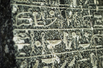 Egyptian hieroglyphs on a ancient stone plate