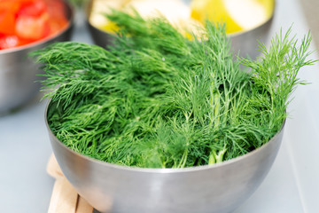 Fresh Organic Dill in a stainless steel bowl.