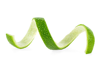 Peel of fresh lime over white background, closeup.