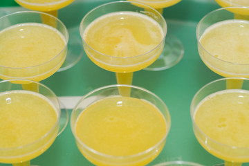 Cold Refreshing Lemon Drink in fancy margarita glasses at a party table.