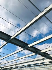 long steel beams against the background of the blue sky