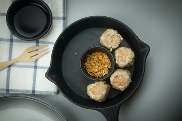 Delicious shrimp dumplings served with fried garlic and soy sauce