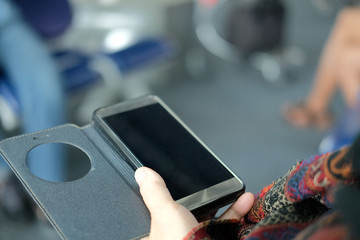 hand holding mobile smart phone at airport