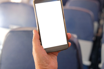 hand holding mobile smart phone on airplane